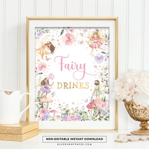May include: A framed print with a gold border featuring the words "Fairy Drinks" in pink and gold. The print is decorated with watercolor illustrations of fairies, flowers, and mushrooms. The bottom of the print reads "NON-EDITABLE INSTANT DOWNLOAD".