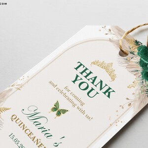 May include: Green and gold thank you tag with a crown and butterfly design. The text reads "Thank You for coming and celebrating with us! Maria's Quincea&ntilde;era 15.05.2023"