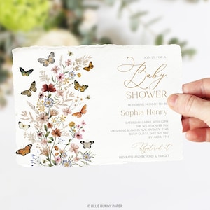 May include: A white baby shower invitation with gold lettering. The invitation features a floral design with butterflies and the text "Join us for a Baby Shower honouring Mommy-to-be Sophia Henry". The invitation also includes the date, time, location, and RSVP information.