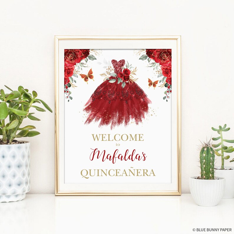 May include: Welcome to Mafalda's Quincea&ntilde;era sign with a red and gold watercolor illustration of a dress with butterflies and flowers.
