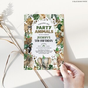 May include: A green and gold jungle-themed party invitation for Zachary's 5th birthday. The invitation features a variety of animals, including a lion, tiger, giraffe, zebra, and elephant. The text on the invitation reads "Calling All Party Animals" and "Zachary's 5th Birthday".