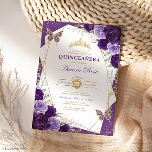 May include: A Quincea&ntilde;era invitation with a purple and gold design. The invitation features floral accents, butterflies, and the text "QUINCEA&Ntilde;ERA" and "Aurora Rose". The date and time of the event are also displayed.
