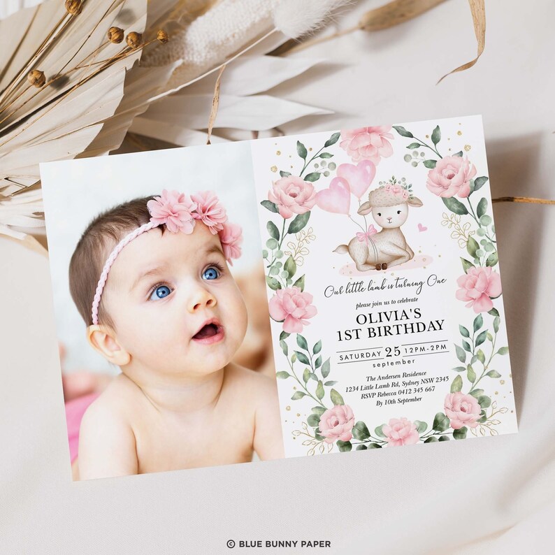 May include: A pink and green floral first birthday invitation with a cute lamb holding pink balloons. The invitation says "Our little lamb is turning one" and includes the name Olivia, the date, and time of the party. The invitation also includes the address and RSVP information.