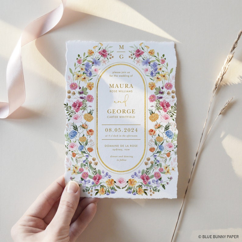 May include: A wedding invitation with a floral border and gold lettering. The invitation reads "Please join us for the wedding of Maura Rose Williams and George Carter Whitfield, 08.05.2024 at 4 o'clock in the afternoon, Domaine de la Rose, Sydney, New. Dinner and dancing to follow."