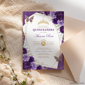 May include: A quincea&ntilde;era invitation with a floral and butterfly design. The invitation features the text "QUINCEA&Ntilde;ERA" and "Aurora Rose" in elegant script. The design includes purple flowers, gold accents, and a geometric frame.