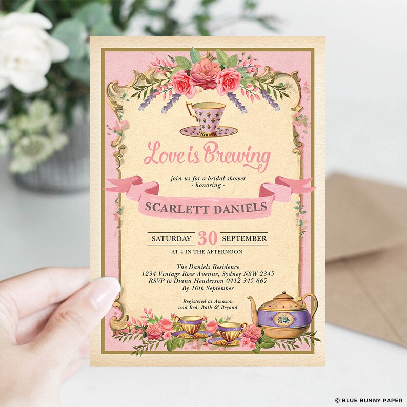 May include: A pink and gold bridal shower invitation with a teacup and teapot illustration. The invitation reads "Love is Brewing" and includes the name "Scarlett Daniels" and the date "Saturday, September 30th".
