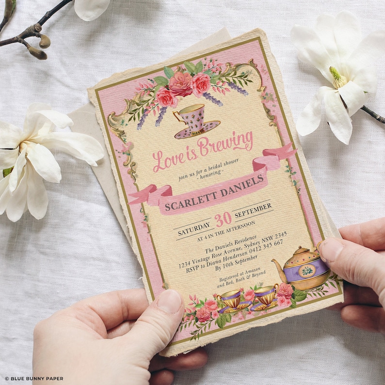May include: A pink and gold bridal shower invitation with a teacup and teapot design. The invitation reads "Love is Brewing" and includes the bride's name, Scarlett Daniels, the date, September 30th, and the time, 4:00 PM. The invitation also includes the address and RSVP information.
