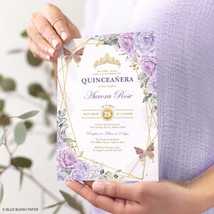 May include: Purple and gold Quincea&ntilde;era invitation with a floral design and a butterfly. The invitation includes the date, time, and location of the event. It also includes the name of the celebrant, Aurora Rose.