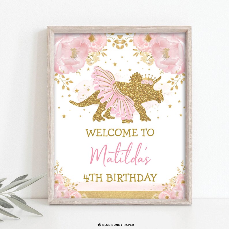 May include: A printable sign for a 4th birthday party featuring a pink and gold glitter dinosaur wearing a tutu. The sign says "Welcome to Matilda's 4th Birthday".
