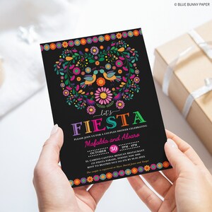 May include: A black and colorful invitation for a couples shower. The invitation features a heart-shaped floral design with birds and the text "Let's Fiesta" in rainbow colors. The text "Please join us for a couples shower celebrating Mafalda and Alvaro" is printed in white. The date and time of the event are listed as "October 30, 2PM-4PM". The location is "El Camino Cantina Mexican Restaurant, 125 Fiesta Parade, Sydney NSW 2000". The RSVP information is "RSVP to Beatriz 6412 345 676 by 08.05.20XX". The bottom of the invitation reads "The couple is registered at Myer, David Jones and Target".