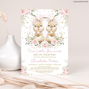 May include: A pink and gold baby shower invitation with two bunnies wearing floral headbands. The invitation reads "Two Little Bunnies Are On Their Way!" and includes the name "Charlotte Potter".
