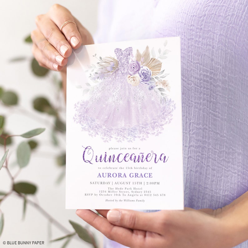 May include: Purple Quincea&ntilde;era invitation with a watercolor illustration of a lavender dress, flowers, and greenery. The text reads "Please join us for a Quincea&ntilde;era to celebrate the 15th birthday of Aurora Grace. Saturday, August 15th, 2:00 PM. The Hyde Park Hotel, 1234 Miller Street, Sydney 2545. RSVP by October 10th to Angela at 0412 345 678. Hosted by the Williams Family."