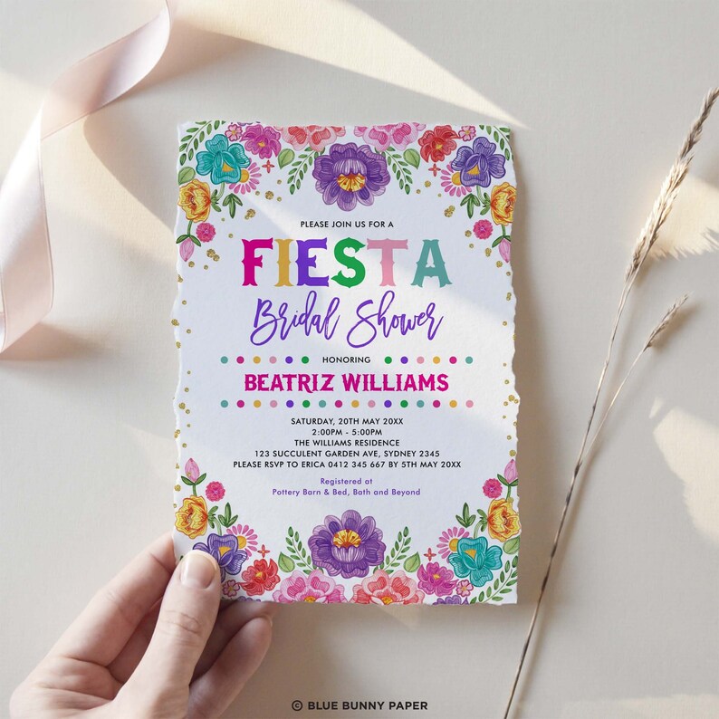 May include: A colorful fiesta bridal shower invitation with a white background and gold glitter. The invitation features a floral border with colorful flowers and leaves. The text "FIESTA Bridal Shower" is in rainbow colors. The invitation also includes the bride's name, the date, time, and location of the shower. The text "Registered at Pottery Barn & Bed, Bath and Beyond" is at the bottom of the invitation.