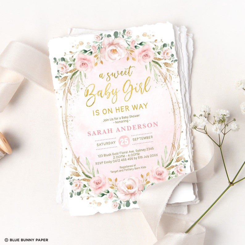 Może przedstawiać: R&oacute;żowe i złote zaproszenie na baby shower z wieńcem kwiatowym i tekstem "a sweet Baby Girl is on her way". Zaproszenie zawiera datę, godzinę i miejsce imprezy, a także imię osoby, kt&oacute;rej impreza jest poświęcona, Sarah Anderson.