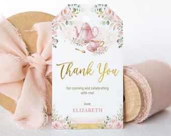May include: A pink and gold thank you tag with a floral design and a teapot and teacup illustration. The text reads "Thank You for coming and celebrating with me! love, ELIZABETH".