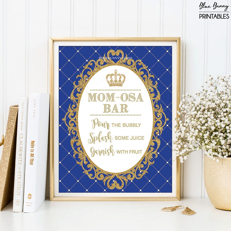 May include: A printable sign for a royal themed party. The sign is blue with a gold frame and a crown. The text on the sign reads "Mom-osa Bar" and "Pour the bubbly, Splash some juice, Garnish with fruit".