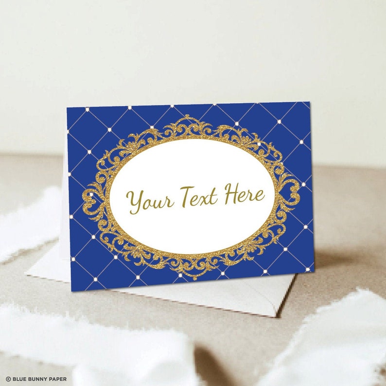 May include: Blue and gold printable place card with a decorative frame and the text "Your Text Here".