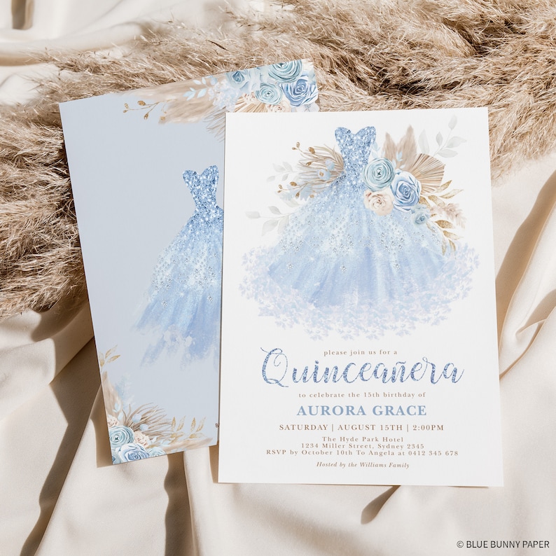 May include: A blue and white Quincea&ntilde;era invitation with a watercolor illustration of a blue ball gown with floral accents. The text reads "Please join us for a Quincea&ntilde;era to celebrate the 15th birthday of Aurora Grace. Saturday, August 15th, 2:00 PM. The Hyde Park Hotel, 1234 Miller Street, Sydney 2345. RSVP by October 10th to Angela at 0412 345 678. Hosted by the Williams Family."