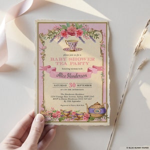 May include: Pink and gold baby shower tea party invitation with floral design and a teapot and teacups. The invitation says "Please join us for a Baby Shower Tea Party honouring mummy-to-be Alice Henderson. Saturday, 30th September at 4 in the afternoon. The Henderson Residence, 1234 Vintage Rose Avenue, Sydney NSW 2345. RSVP to Diana Henderson 0412 345 667 by 10th September. Registered at Pottery Bark Kids."