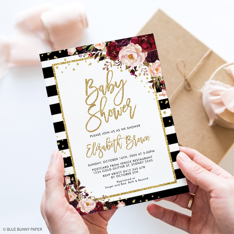 May include: Black and white striped baby shower invitation with gold glitter and floral accents. The invitation reads "Baby Shower" and "Elizabeth Brown".
