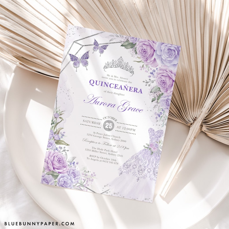 May include: Purple and silver Quincea&ntilde;era invitation with a floral design and a butterfly. The invitation includes the date, time, and location of the event. It also includes the name of the celebrant, Aurora Grace.