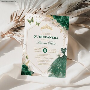 May include: A green and gold quincea&ntilde;era invitation with a floral design and a crown. The invitation includes the text "Quincea&ntilde;era" and "Aurora Rose". The date and time of the event are listed as "October 25th at 12:00 PM".