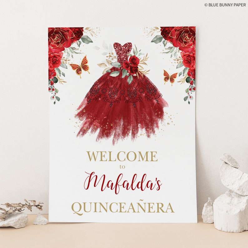 May include: Welcome to Mafalda's Quincea&ntilde;era sign with a red and gold watercolor illustration of a dress with butterflies and flowers.