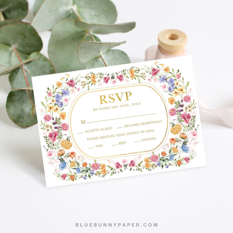 May include: A floral RSVP card with a gold border and text. The text reads "RSVP by February 10th, 20XX". The card has a section for guests to indicate their attendance and meal choice.
