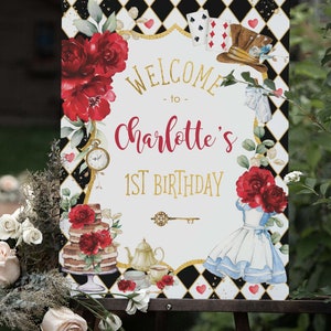 May include: Welcome to Charlotte's 1st Birthday party sign with a black and white checkered background, red roses, a teacup, teapot, cake, and Alice in Wonderland characters.
