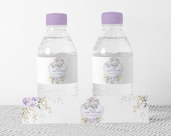May include: Two clear plastic water bottles with purple lids and labels. The labels feature a watercolor illustration of a baby elephant with purple flowers and the text "Ella's Baby Shower 15.01.20XX". A smaller label with the same design is also shown.