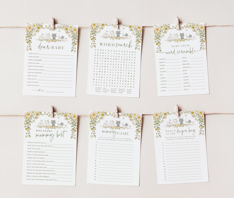 Op de afbeelding: Een set van zes printbare babyshower-spelkaarten met een bloemen- en kattenmotief. De kaarten bevatten spellen zoals "Lieve baby", "Woordzoeker", "Babyartikel-woordensalade", "Wie kent mama het beste", "Geheugenspel" en "Wat zit er in de luiertas".