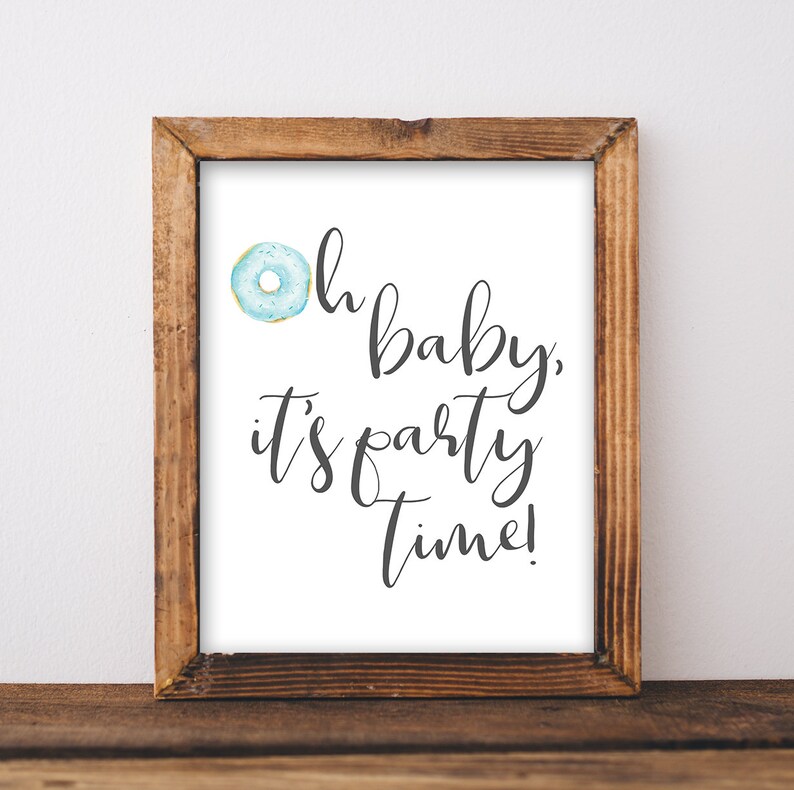 May include: A framed print with a blue and white donut illustration and the text "Oh baby, it's party time!"