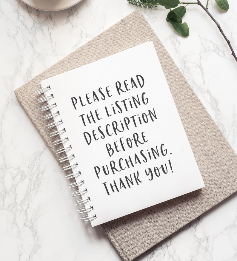 May include: A white notebook with a spiral binding, lying on a beige fabric surface. The notebook has the text "PLEASE READ THE LISTING DESCRIPTION BEFORE PURCHASING. THANK YOU!" written in black.