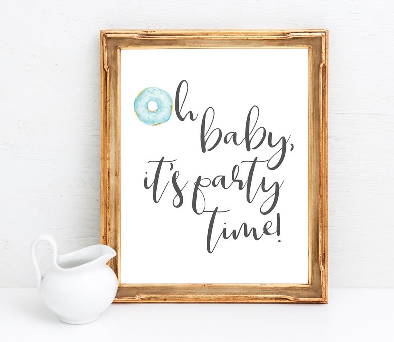 May include: A framed print with a blue donut and the text "Oh baby, it's party time!"