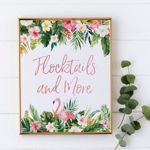 May include: A gold framed sign with a tropical floral border and a pink flamingo. The sign says "Flocktails and More".
