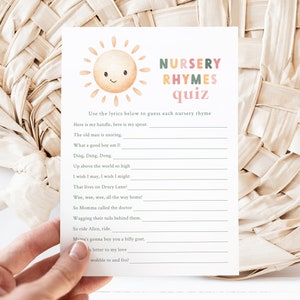 May include: A printable nursery rhyme quiz with a colorful sun illustration. The quiz asks players to guess the nursery rhyme based on a line of lyrics. The lyrics include: "Here is my handle, here is my spout", "The old man is snoring", "What a good boy am I!" and more.