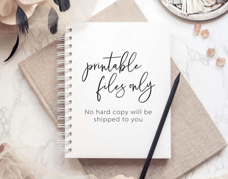 May include: A white notebook with a black spiral binding. The notebook has the text "printable files only" written in black cursive script. Below the text is the sentence "No hard copy will be shipped to you" in black print.