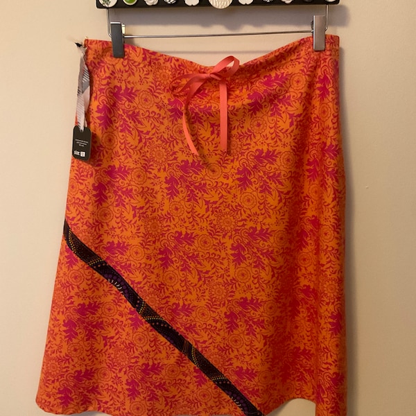 A-line, bias cut cotton skirt, vibrant orange with fuchsia floral print, length options.