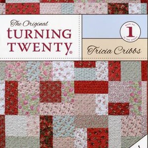 May include: The Original Turning Twenty quilt pattern book by Tricia Cribbs. The cover features a red and white patchwork quilt design with floral fabric. The text "Fast, easy & fun!" is printed on the bottom right corner.