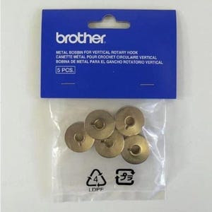 May include: A package of 5 gold metal bobbins for a vertical rotary crochet hook. The package is labeled "brother" and "5 PCS."