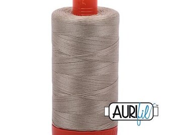 May include: A spool of light gray thread with a red and orange plastic bobbin. The thread is labeled "Aurifil" in blue lettering.