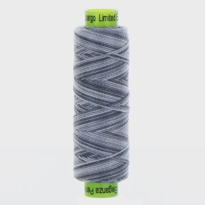 May include: A spool of variegated thread featuring a gradient of light gray, medium gray, and dark gray tones. The spool has bright lime green plastic caps on the top and bottom, with the text "Eleganza Perle" and "pargo Limited E" printed on them.