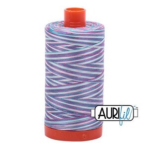 May include: A cylindrical spool of sewing thread featuring a variegated pattern of white, light blue, and magenta stripes. The spool has a bright orange plastic top and base, with the brand name AURIfil printed in black on a white rectangular label.