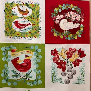 May include: A Christmas fabric panel with a white background and four squares. Each square features a different holiday scene with birds, flowers, and greenery. The top row features a red cardinal and a robin, the bottom row features a cardinal with the word "Peace" and two yellow birds with bells. The fabric panel is bordered by a row of stylized trees.
