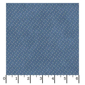 May include: Blue fabric with a repeating pattern of small, off-white dashes arranged in diagonal rows. The fabric has a textured appearance, and a ruler is placed along the bottom edge, with markings from 0 to 6 inches.