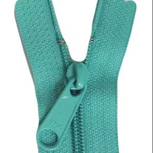 May include: A close-up of a teal zipper, with the zipper pull in the open position. The zipper teeth are interlocked, and the pull tab is marked with the brand name "YKK". The zipper is made of a durable material and is suitable for various sewing projects.