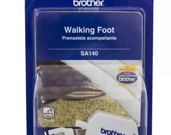 May include: A white walking foot sewing machine presser foot with a Brother logo. The foot is packaged in a clear plastic blister pack with a blue and white background. The package includes the text "Walking Foot", "Prensatela acompañante", "SA140", and "For Best Results use only Brother Genuine Accessories".