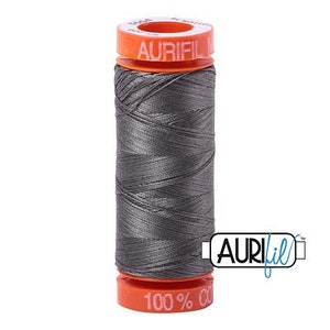 May include: A spool of gray Aurifil thread with a 100% cotton label. The spool is orange and white with the Aurifil logo.