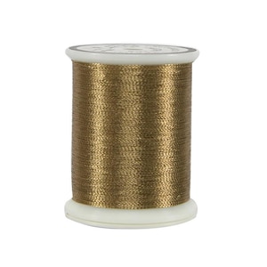 May include: A spool of metallic gold thread, ideal for sewing and embroidery projects. The thread is tightly wound on a white plastic spool. The thread has a shiny, textured appearance, reflecting light.