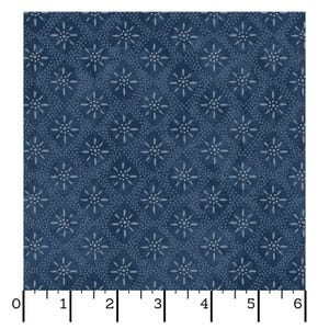 May include: A close-up of a fabric with a repeating pattern of white starbursts and small dots on a dark blue background. The fabric is measured with a ruler in inches.